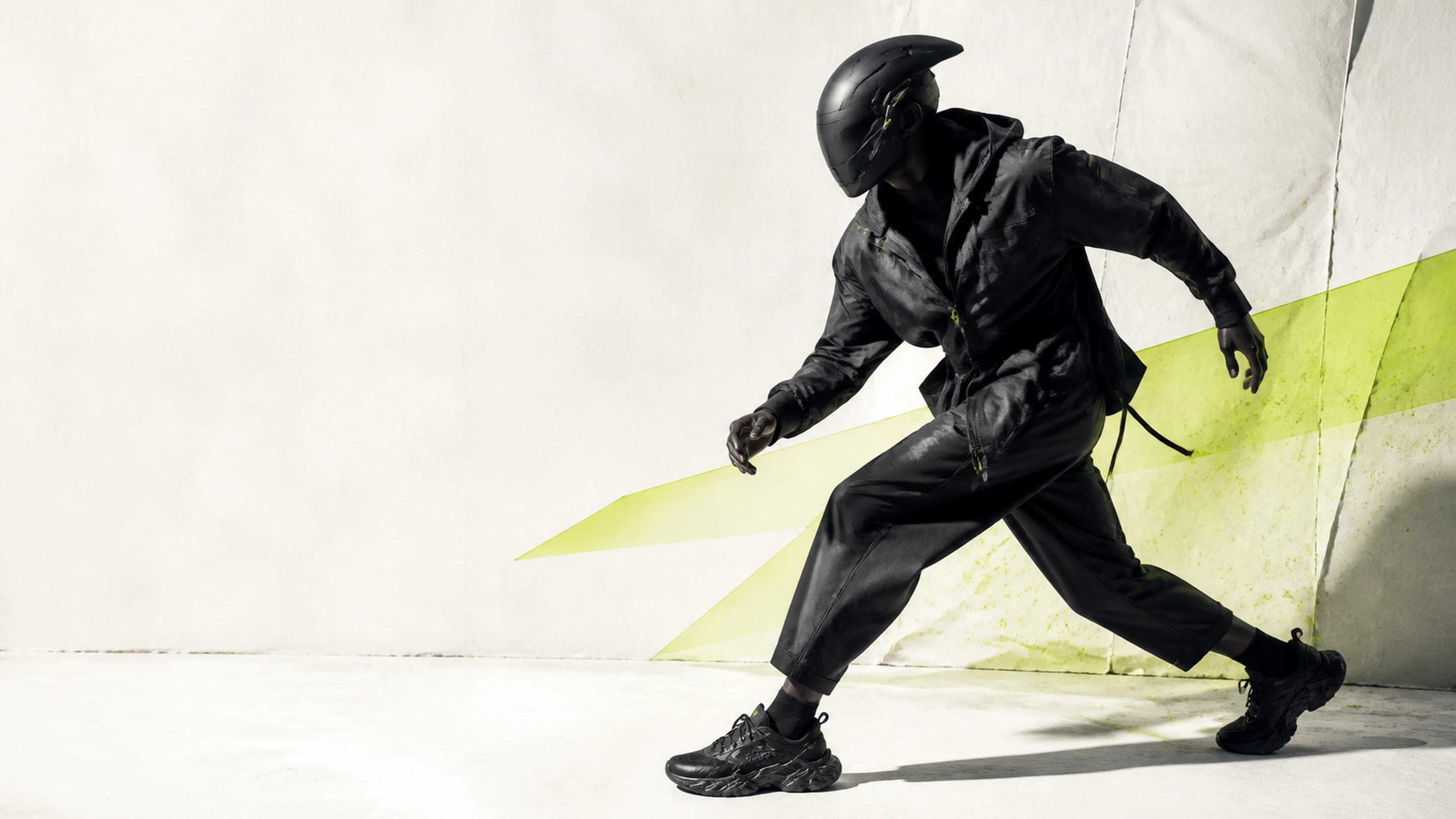 Original black collectible runner turning inside a white studio